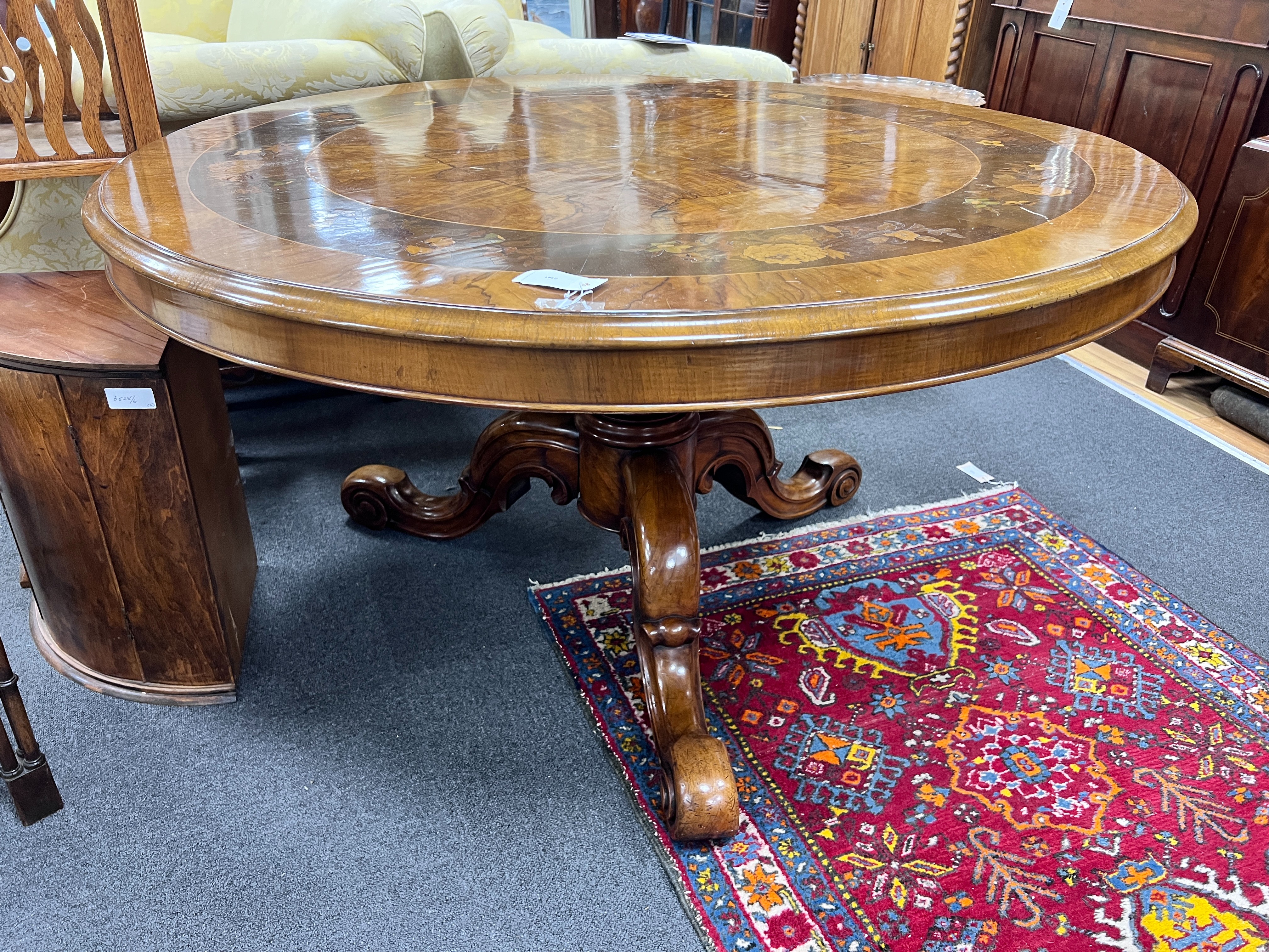 A Victorian floral marquetry inlaid figured walnut circular tilt top breakfast table, diameter 126cm, height 70cm